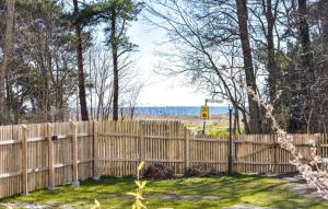 a wooden fence with a view of the beach at Cosy cottage by the south coast in Trelleborg