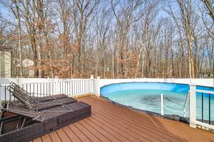 a hot tub on the deck of a house at Poconos Home with Private Pool, Hot Tub and Sauna! in East Stroudsburg