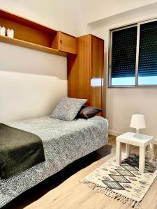 a bedroom with a bed and a table and windows at Santo Domingo in Santa Cruz de Tenerife