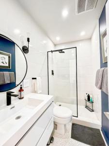 a white bathroom with a toilet and a shower at Cozy Studio Retreat with Shared Pool - MK4-WW in Los Angeles