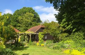 an old house with a garden in front of it at The Barn - Quiet Location in Ashford