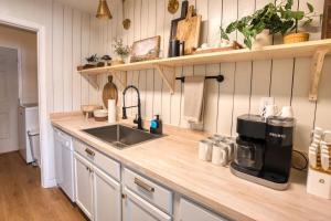 a kitchen counter with a sink and a coffee maker at Southern Travel - Charming 3 Bedroom in Moultrie