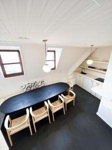 a dining room with a large table and chairs at Le FauBourg Suites in Antwerp