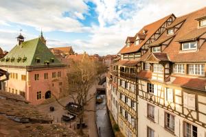 a view of a city with buildings and a river at Travel Homes - Tanneur 6, heart of Petite Venise in Colmar
