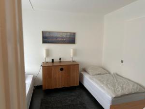 a small bedroom with a bed and a wooden cabinet at Schöne Zimmervermietung für Monteure geeignet ! Direkt am Kanal mit Gartennutzung! in Hamm