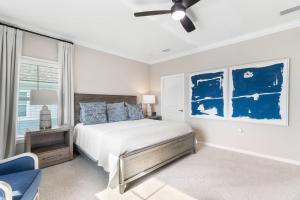 a bedroom with a bed and a ceiling fan at Living In Luxury in Pensacola