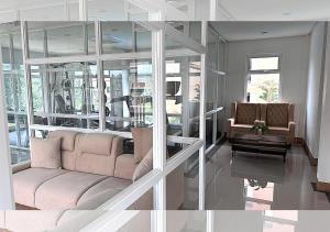 a living room with a couch and a table at Spacious 2BR Staycation with FREE Gym, Parking & Pool - B2 1Nambulite in Puerto Princesa City
