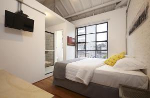 Krevet ili kreveti u jedinici u okviru objekta Guest Urban Hotel Design Pinheiros