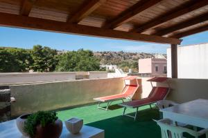 a patio with chairs and a table on a roof at Appartamenti Leone1 in San Vito lo Capo