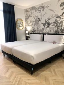 Postel nebo postele na pokoji v ubytování Oriente Atiram Hotel