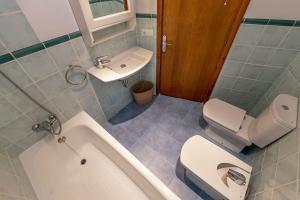 a bathroom with a tub and a toilet and a sink at Llenaire 2, Sea view, pool, AC in Port de Pollensa +8 photos