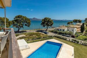 a villa with a swimming pool and a view of the water at Llenaire 2, Sea view, pool, AC in Port de Pollensa