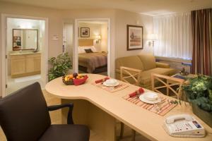 a living room with a table and a bedroom at Candlewood Suites Indianapolis East by IHG in Indianapolis