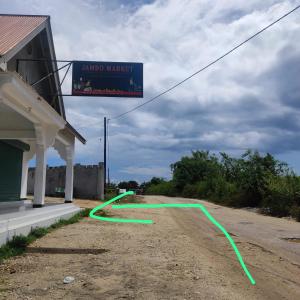 a green hose on the side of a gas station at Zanzibat bungalow in Kendwa