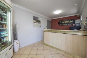 a restaurant lobby with a counter and a sign on the wall at Cotswold Motor Inn in Toowoomba