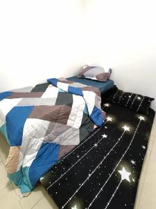 a bedroom with a bed with stars on it at Indera Sempurna Ruma Aisya in Kuantan