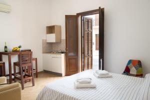 a bedroom with a bed with two towels on it at Camera Tonnarella in San Vito lo Capo