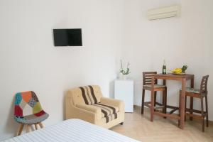 a bedroom with a bed and a table and chairs at Camera Tonnarella in San Vito lo Capo