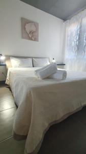- un lit blanc avec un livre au-dessus dans l'établissement Corinna family, à Casal Palocco