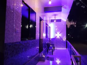 a night view of a house with purple lights at PRESLEY RESIDENTS in Māvalli