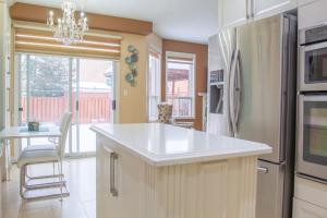 a kitchen with a white counter top and a refrigerator at Royal Luxury Central Home with Gazebo By Toronto in Brampton
