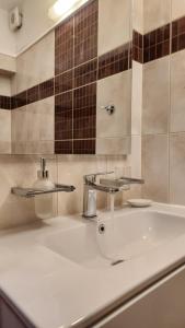 a white bathroom with a sink and a mirror at Nian Apartments - by Avelink in Spáta +12 photos