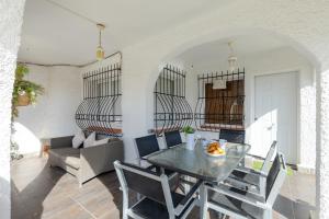 a dining room with a table and chairs at Fidalsa Relax Pool & BBQ in Torrevieja