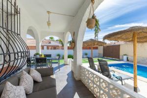 an outdoor patio with a swimming pool and a villa at Fidalsa Relax Pool & BBQ in Torrevieja
