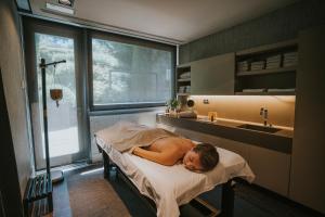 A bed or beds in a room at Mas de Torrent Hotel & Spa, Relais & Châteaux