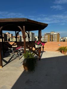 a wooden gazebo on the roof of a building at Relax House 14 in Catania