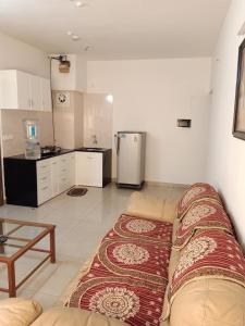 a living room with a couch and a kitchen at 1BHK Service Apartment in Nainital