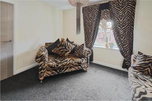 a zebra print couch in a room with a window at Host & Stay - Casa Feliz in Long Riston