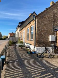 a bike parked next to a brick building at Sejen by the Sea in Landskrona