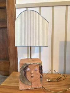 a lamp with a head on top of a table at Casa Bonita in Caserta