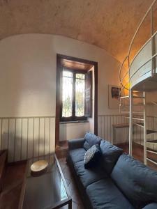 a living room with a blue couch and a window at Casa Bonita in Caserta