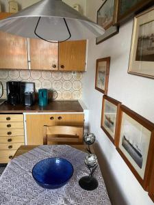a kitchen with a table with a blue plate on it at Sejen by the Sea in Landskrona