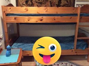 a yellow smiley face toy in front of a bunk bed at Sejen by the Sea in Landskrona