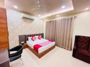a hotel room with a bed and a chair at Hotel ashiyana stay in Lucknow
