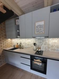 a kitchen with white cabinets and a stove at Bite Le Vanda in Miliai