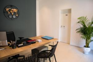 an office with a desk with a computer and a plant at YOUR HOUSE ROOMS 3 in Conversano