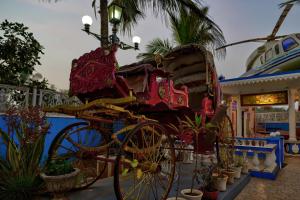 a horse drawn carriage in front of a boat at Lacasita Villas & Cottages near Anjuna Beach & Shiva Valley in Anjuna