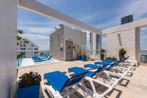 a row of blue and white lounge chairs on a roof at Hampton by Hilton Cartagena in Cartagena de Indias