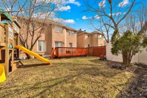 a playground with a slide in a yard at Individual Bedroom - Charming Private Room and Ensuite in Shared Home in Mississauga