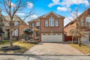 a brick house with a white garage at Individual Bedroom - Charming Private Room and Ensuite in Shared Home in Mississauga