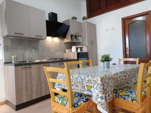 a kitchen and dining room with a table and chairs at A Casicedda in Lipari