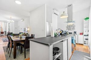a kitchen and dining room with a table and chairs at Renovated 3BR with Private Backyard in Bed-Stuy in Brooklyn