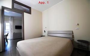 a bedroom with a large bed and a sliding glass door at Le Case Di Nonna Angela in Matera
