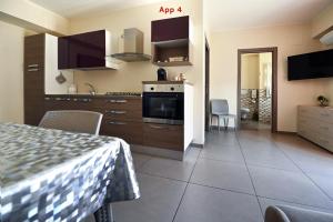 a kitchen with a table and a stove top oven at Le Case Di Nonna Angela in Matera