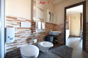 a bathroom with a toilet and a sink at Le Case Di Nonna Angela in Matera +61 photos