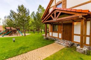 a house with a yard with a playground at Domek A 182 Leśne Zacisze- Kaszubska Ostoja in Barkocin